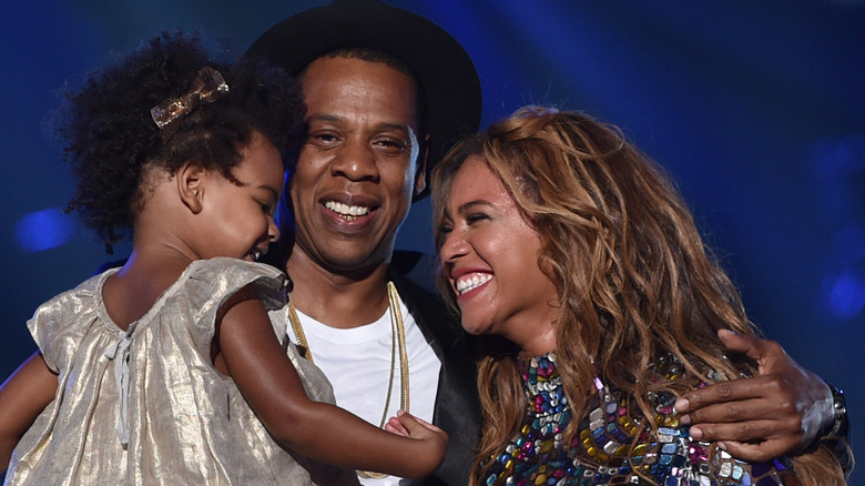 Jay-Z, holding baby Blue Ivy, Beyonce smiling