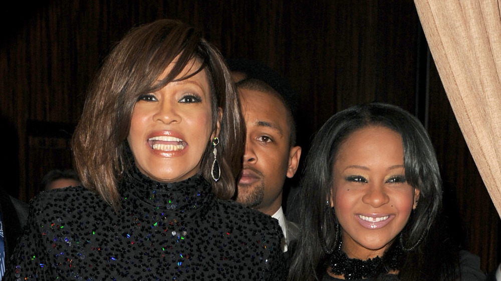 Whitney Houston and daughter Bobbi Kristina Brown enter an event together