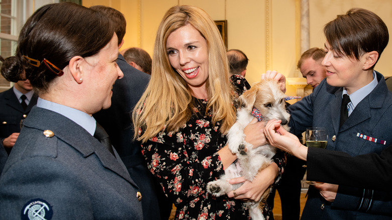 Carrie Johnson and her dog speaking with military 