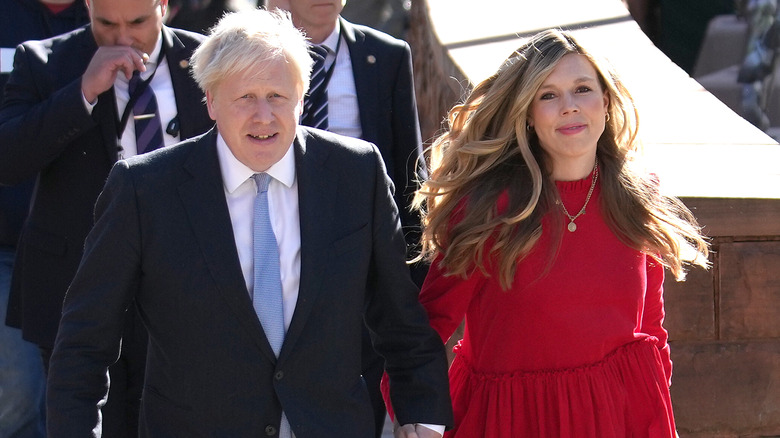 Boris and Carrie Johnson holding hands, smiling