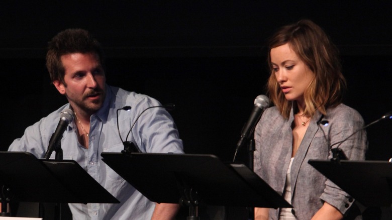 Olivia Wilde and Bradley Cooper with microphones