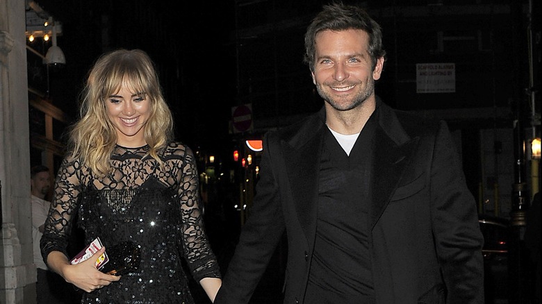 Suki Waterhouse and Bradley Cooper walking