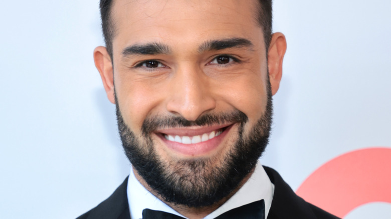 Sam Asghari attending an event, smiling big