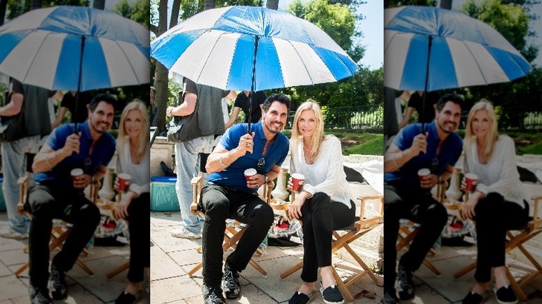 Don Diamont holding an umbrella with Katherine Kelly Lang