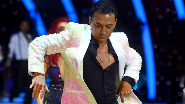 Bruno Tonioli dancing with a sequined white blazer