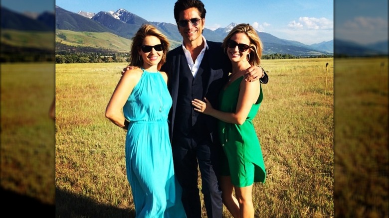 Candace Cameron Bure, John Stamons, and Andrea Barber posing in field