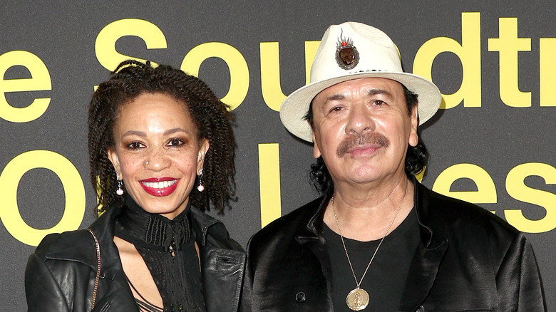 Carlos Santana and wife Cindy Blackman pose on the red carpet together