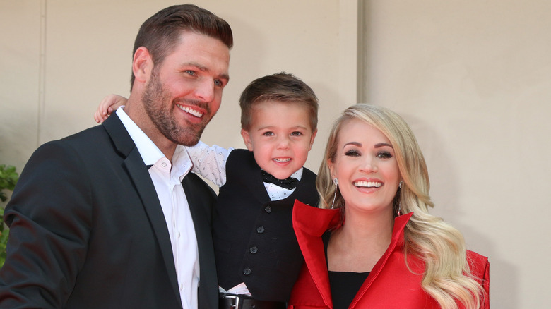 Mike Fisher, Carrie Underwood with their son 