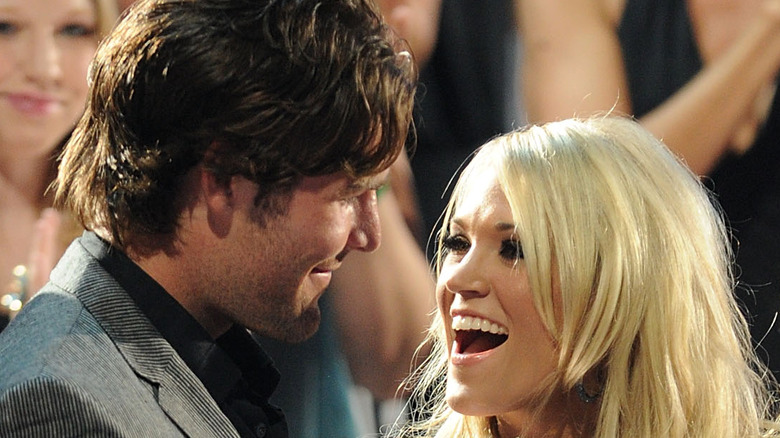 Mike Fisher smiling at Carrie Underwood