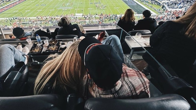 Kelsea Ballerini, Chase Stokes at football game