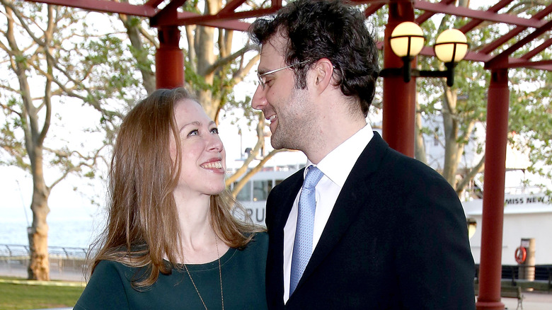 Chelsea Clinton and Marc Mezvinsky smiling at each other