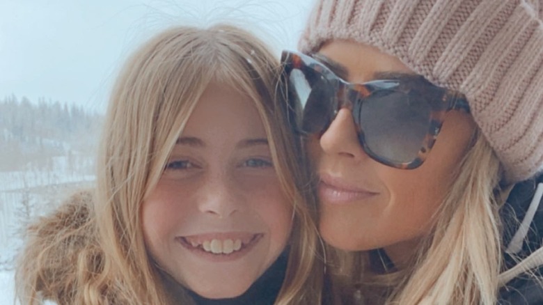 Christina Hall and daughter Taylor smile in a winter selfie with a snowy background