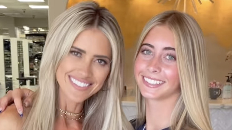 Christina Hall and her daughter smile in salon with matching blond hair