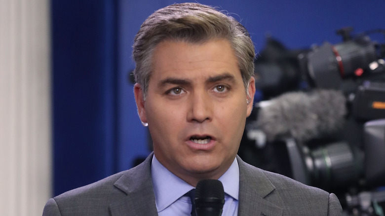 Jim Acosta talking into microphone