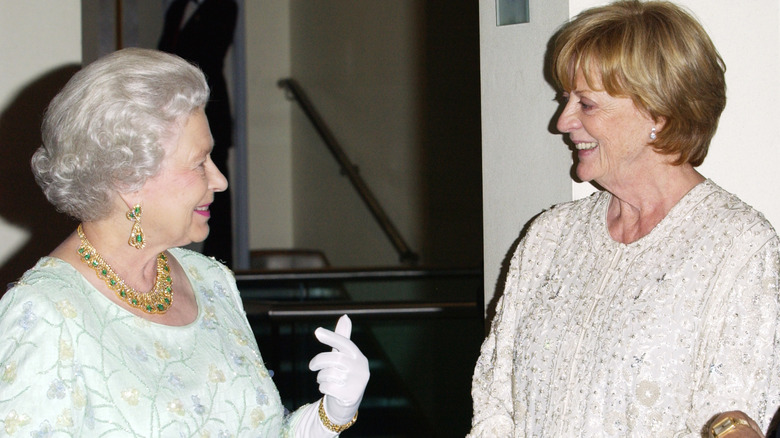 Queen Elizabeth II and Dame Maggie Smith smiling at each other