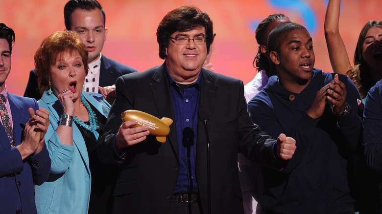 Dan Schneider winning an award onstage with Nickelodeon actors