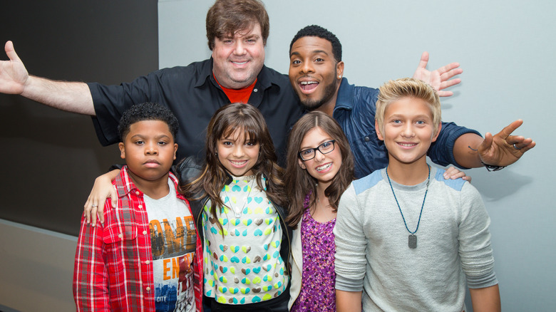 Dan Schneider posing with young Nickelodeon stars