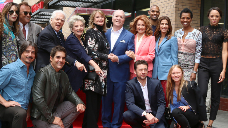 Days of Our Lives cast members pose for a photo. 