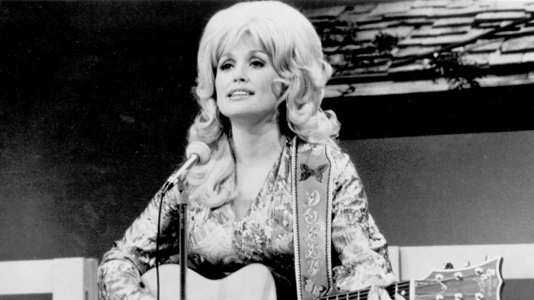 Dolly Parton singing and playing guitar