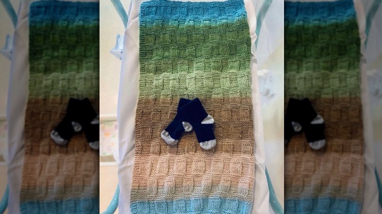 baby socks on a multicolored baby blanket