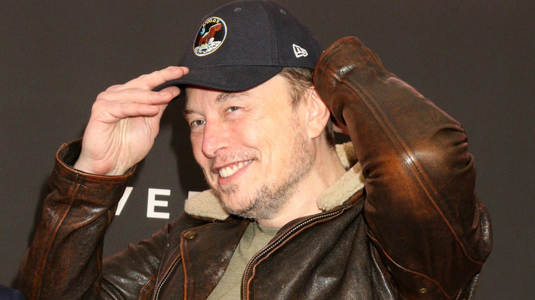 Elon Musk wearing baseball hat at a movie screening