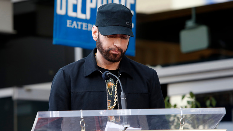 Eminem standing at a podium