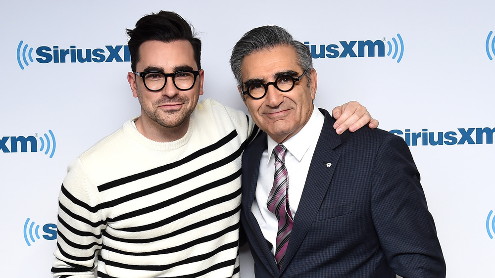 Dan Levy and Eugene Levy smiling at SiriusXM studios