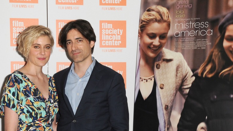 Greta Gerwig and Noah Baumbach pose next to a Mistress America poster