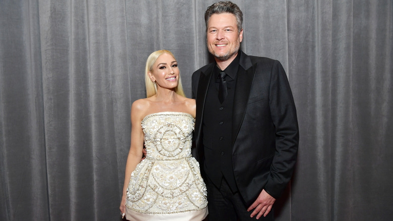 Gwen Stefani and Blake Shelton smiles.