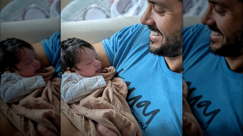 Marco Grazzini cradles his newborn daughter