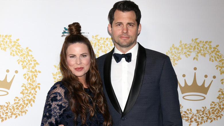 Kristoffer Polaha and wife Julianne Morris smile at black tie event