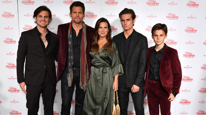 Kristoffer Polaha poses with his wife and sons on event red carpet