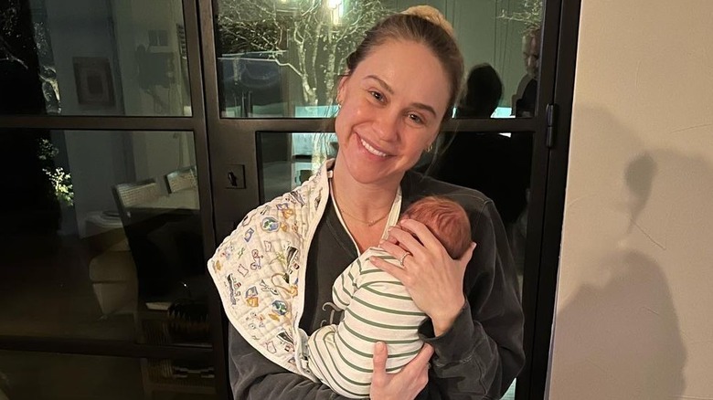 Becca Tobin holding her baby