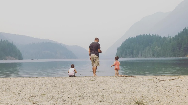 Rear view of Erica Cerra's husband and children on a foggy beach