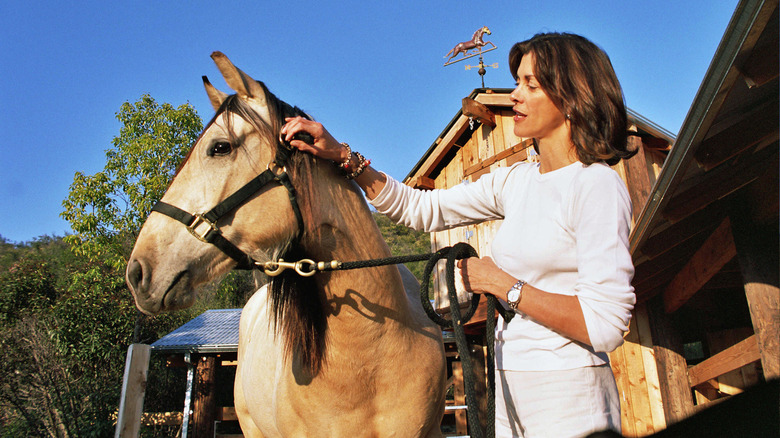 Wendie Malick petting a horse