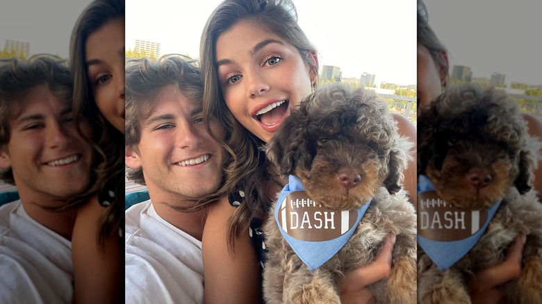 Hannah Ann Sluss and Jake Funk holding dog