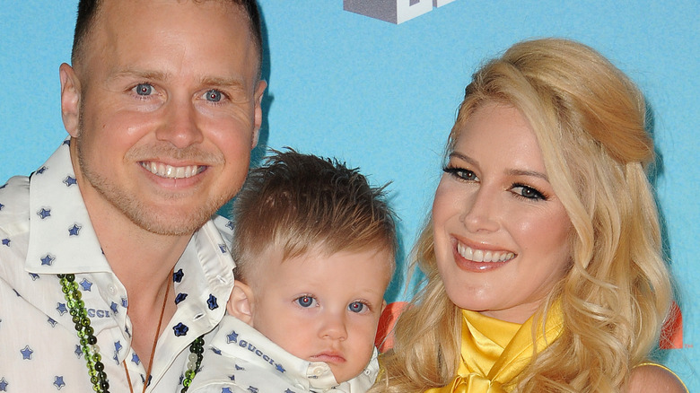 Heidi Montag and Spencer Pratt smiling with their son