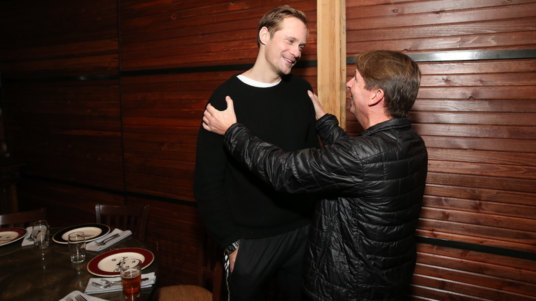 Alexander Skarsgard and Jack McBrayer smiling 