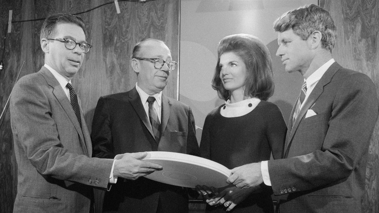 Jackie and Bobby Kennedy receiving film reel