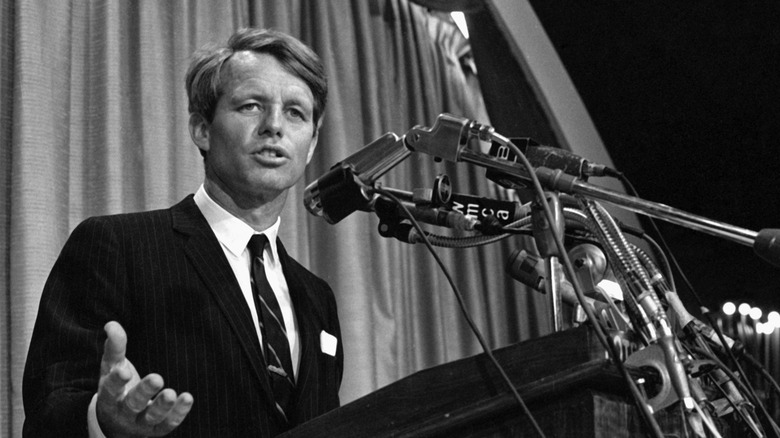 Robert F Kennedy speaking into microphones