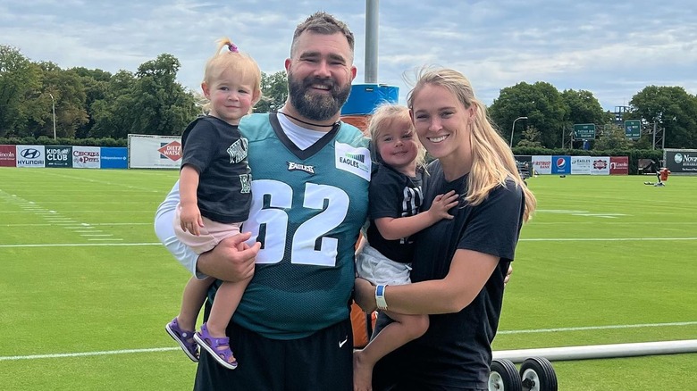 Jason and Kylie Kelce smiling with two daughters