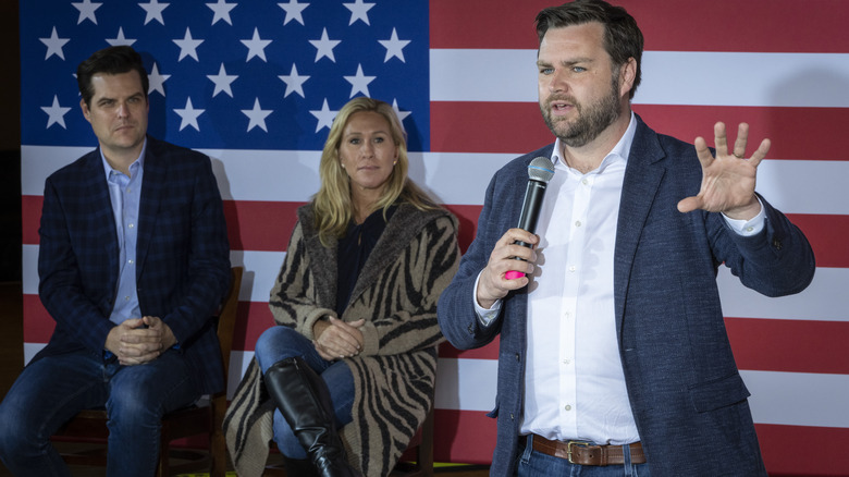 J.D Vance delivering a speech with Marjorie Taylor Greene watching