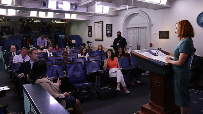 Jen Psaki listening to Peter Doocy