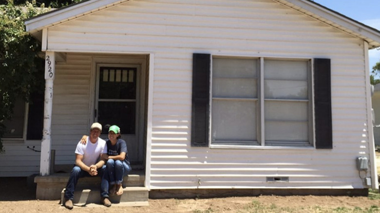 Chip and Joanna Gaines posing with first house 