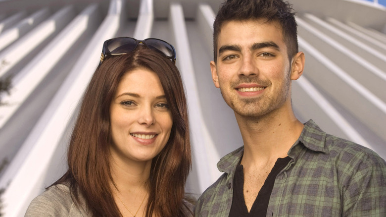 Joe Jonas and Ashley Greene smiling space mountain