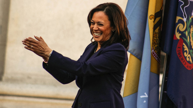 Kamala Harris smiling and clapping