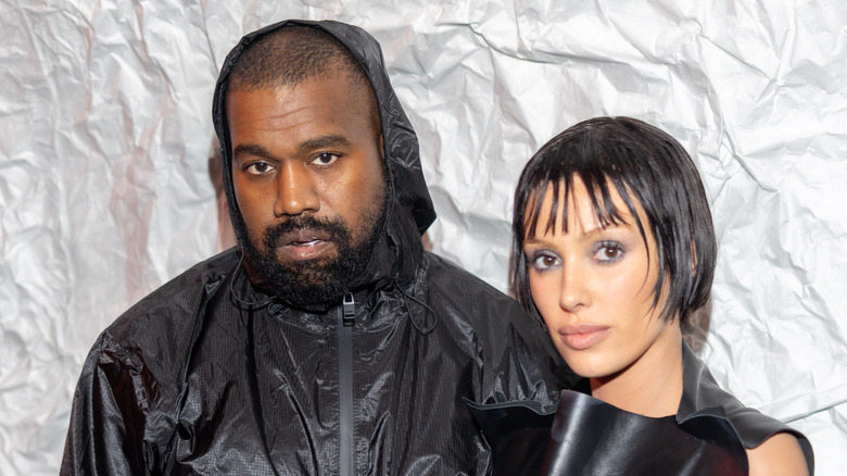 Kanye West and wife Bianca Censori posing solemnly in a public appearance