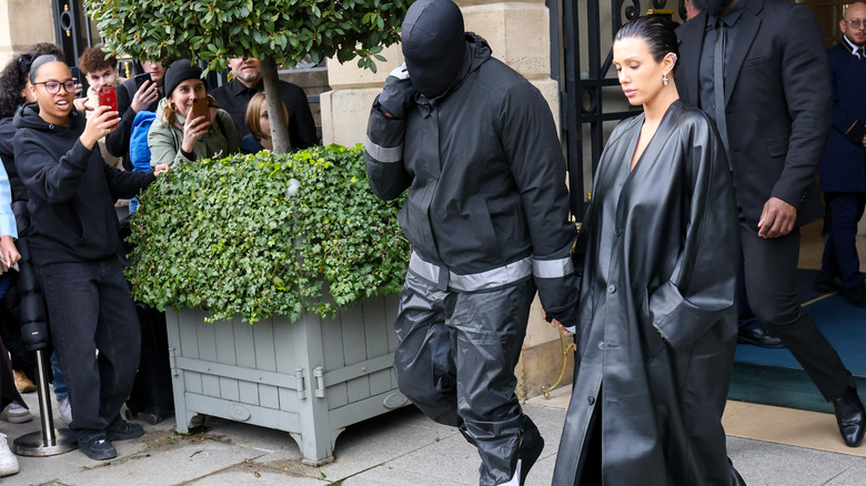 Kanye West and wife Bianca Censori walking while dressed in black