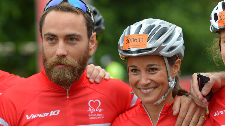 James and Pippa Middleton smiling during charity event