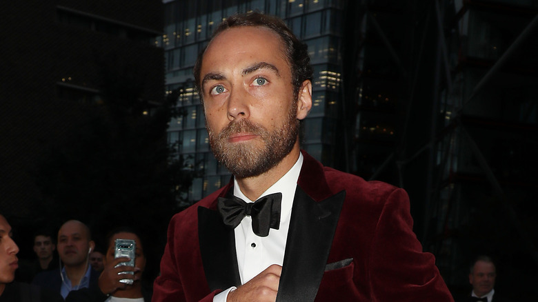 James Middleton walking and looking away